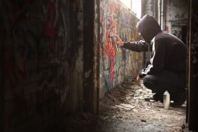 Vandalism Defense in Cincinnati - Man with Spray Paint on Wall 